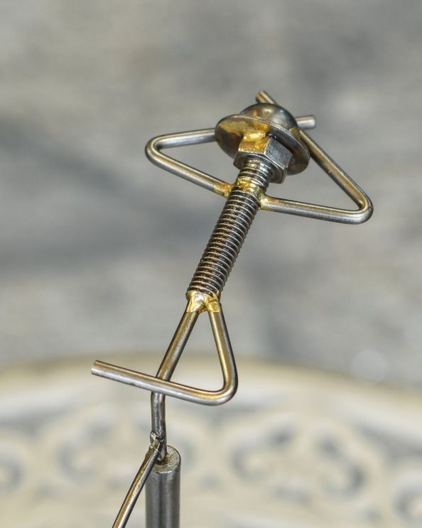 Close Up Of 'The Laid Back' Balancing Scrap Metal Art Sculpture