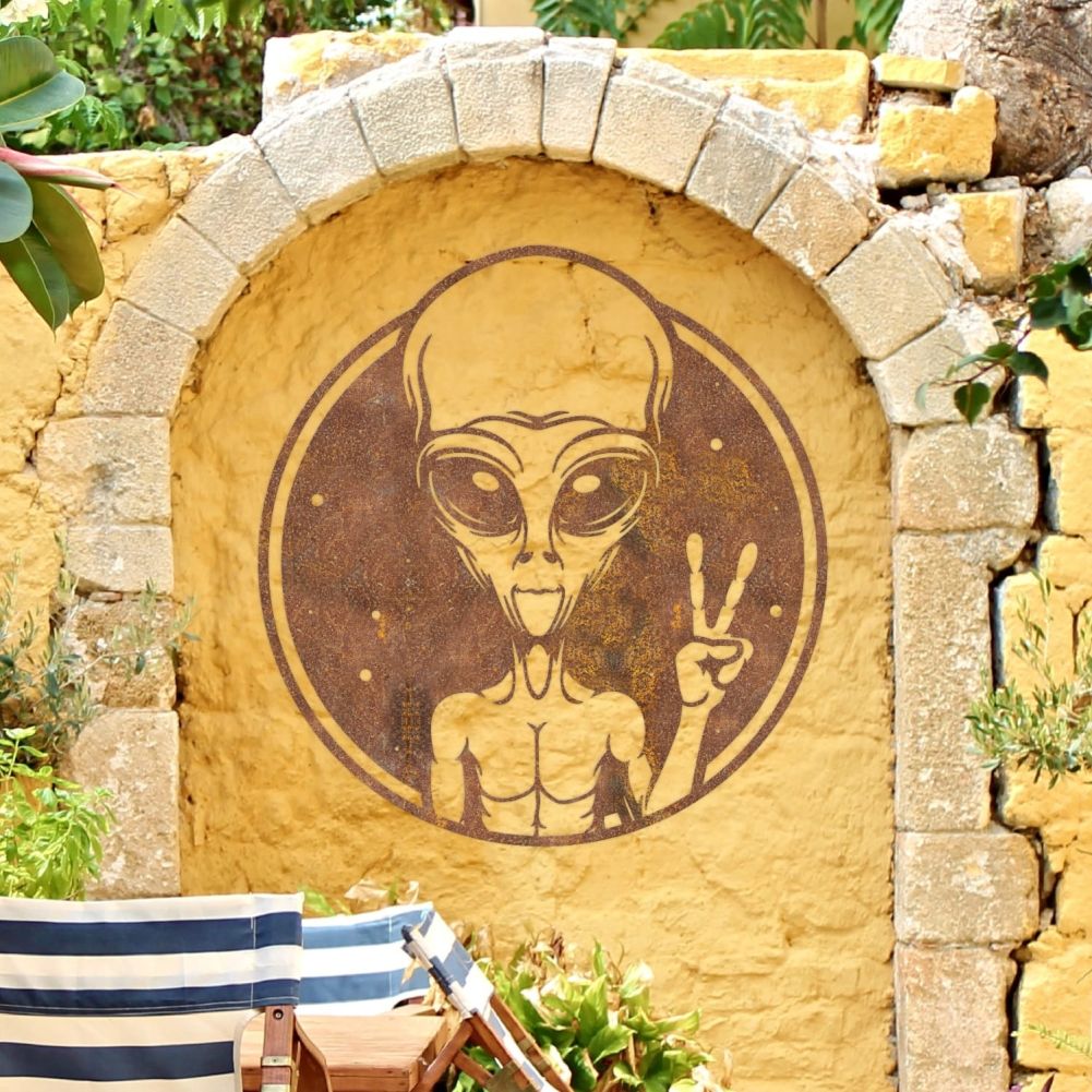 Rustic Alien Peace Sign Wall Art On a Yellow Outside Wall
