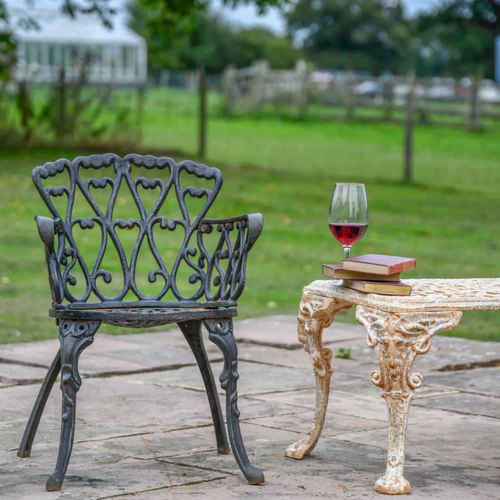 Black Cast Iron Heart Scrolled Garden Chair in Situ