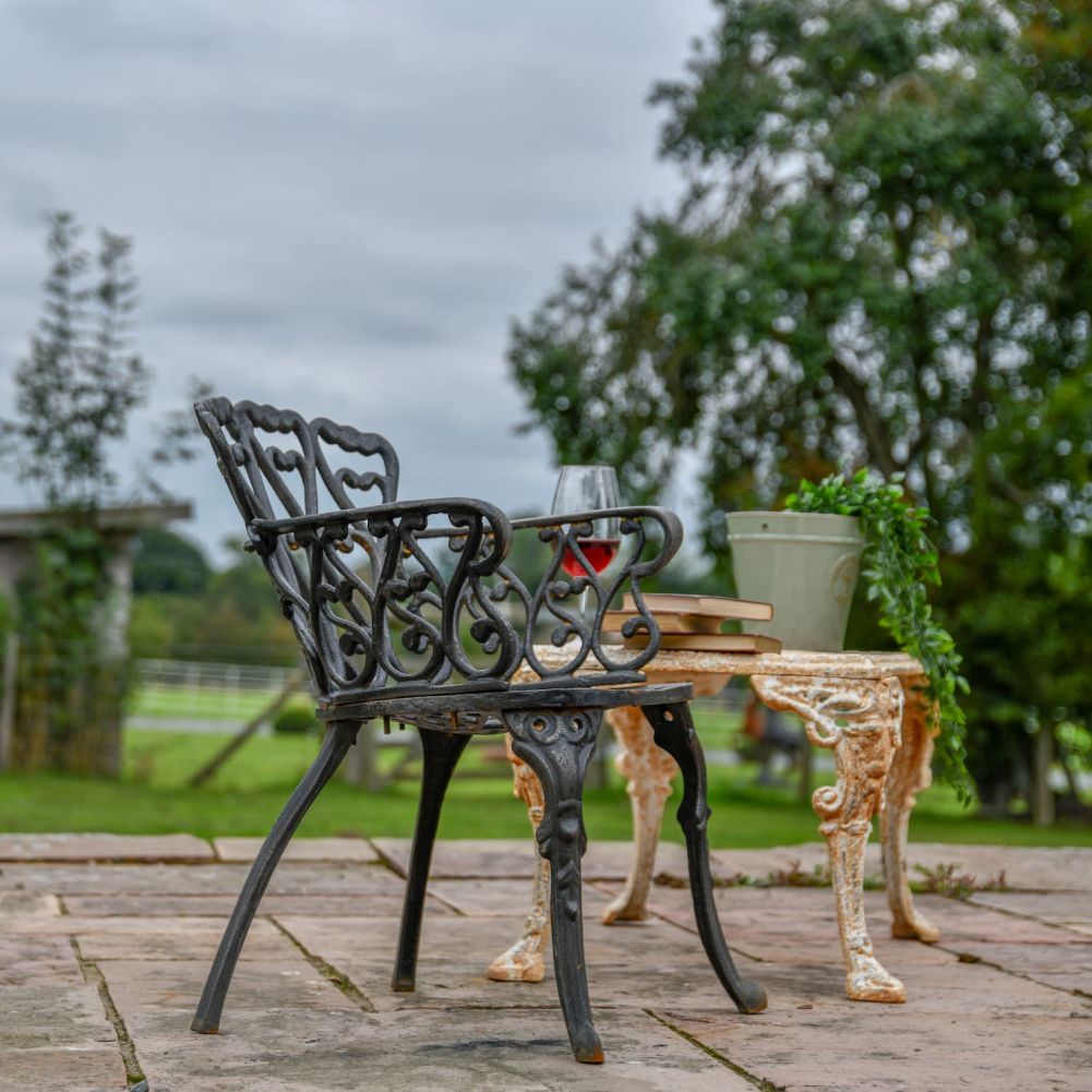 Black Cast Iron Heart Scrolled Garden Chair in Situ