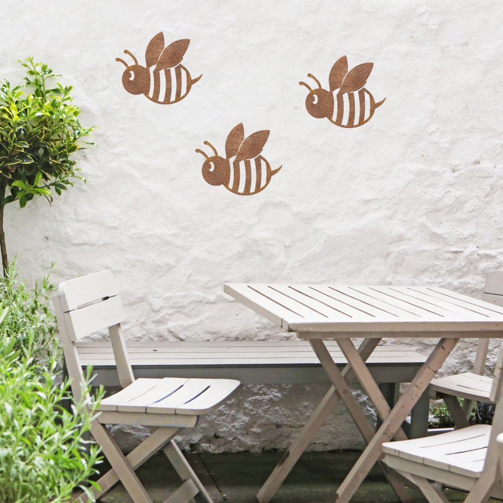 3 Rustic Cartoon Bees On a White Outside Wall
