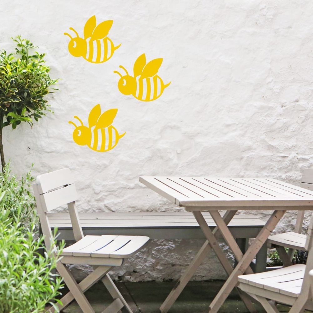 3 Yellow Cartoon Bees On a White Outside Wall