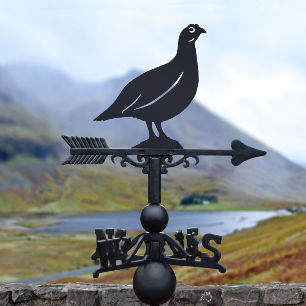 Miniature Red Grouse Weathervane in front of a lake