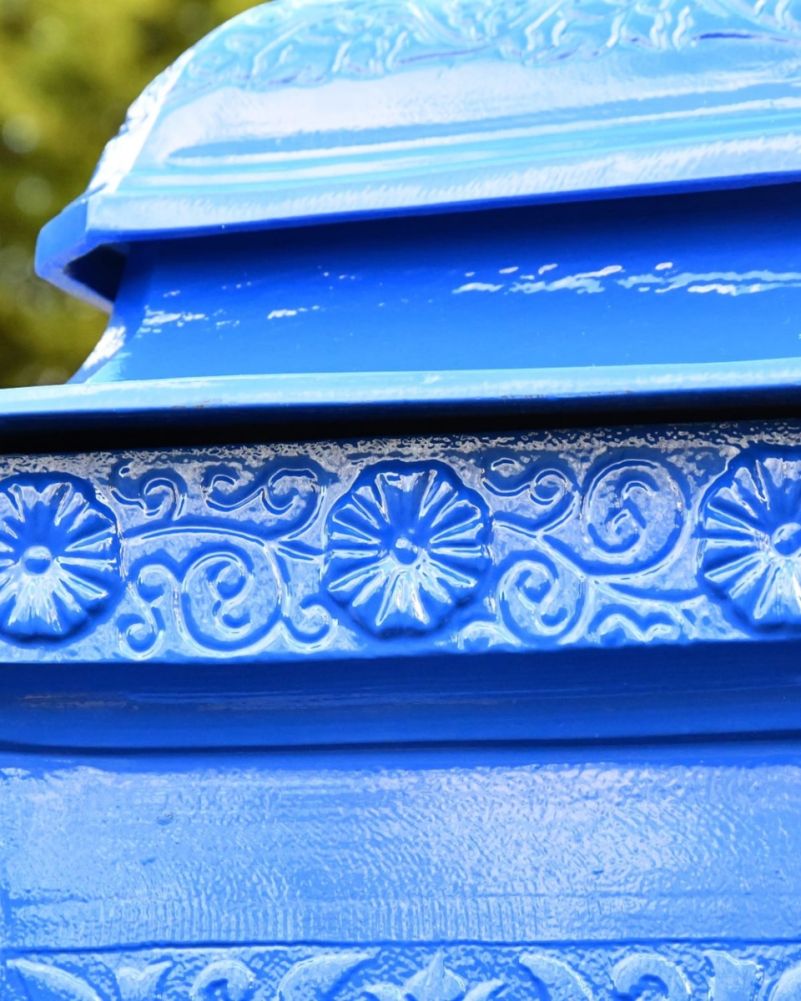 Close up of floral decorative detailing around top of post box 