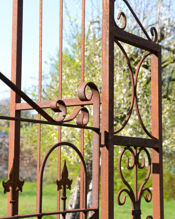 Close Up Details Of The Rustic Garden Rose Arch With A Ornate Gate