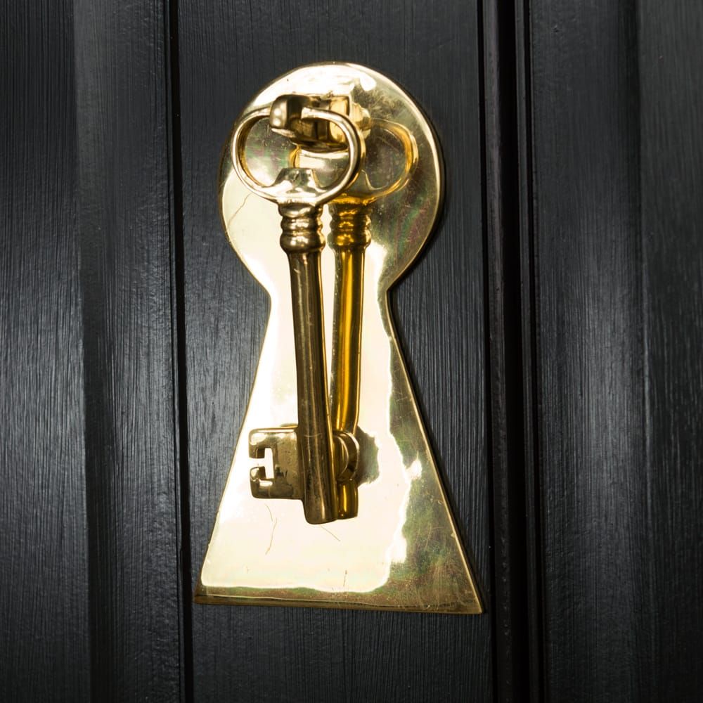 Solid Polished Brass Key Design Door Knocker on Black Door