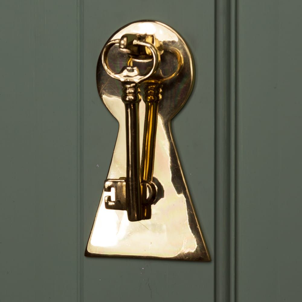 Solid Polished Brass Key Design Door Knocker on Green Door