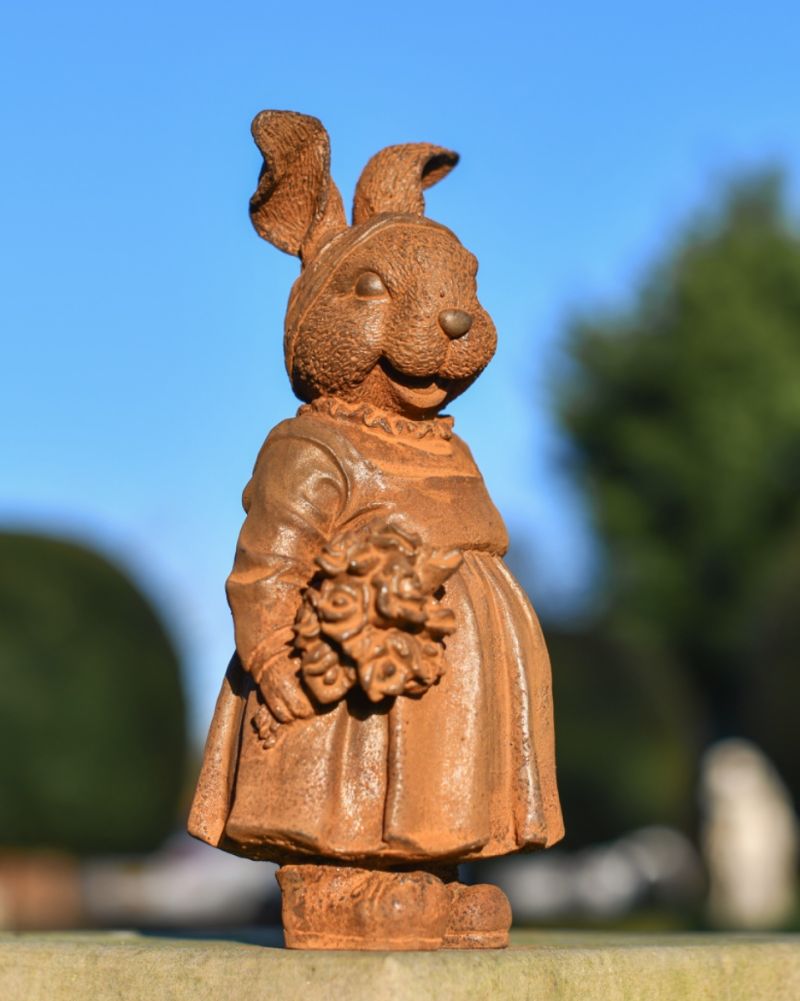 Rustic cast iron rabbit garden sculpture side view 