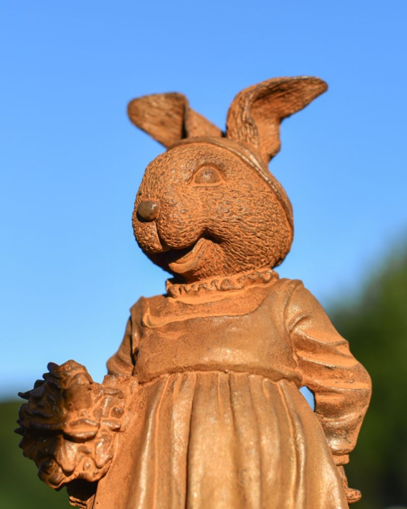 Rustic cast iron rabbit garden sculpture close up image
