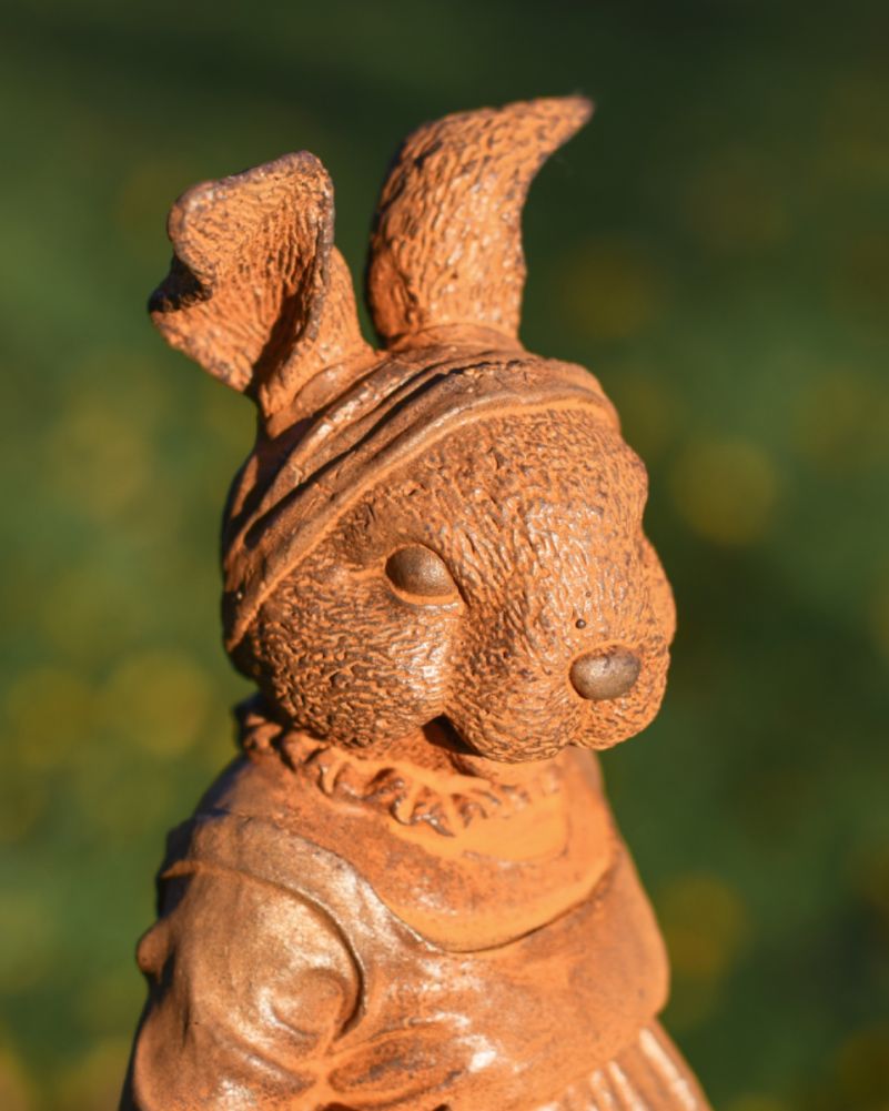 Rustic cast iron rabbit garden sculpture close up side profile