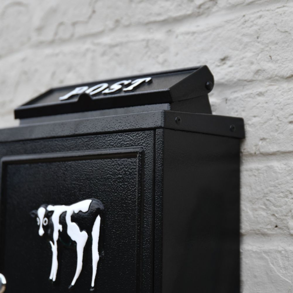 Close up of Cow Motif and white 'POST' lettering 