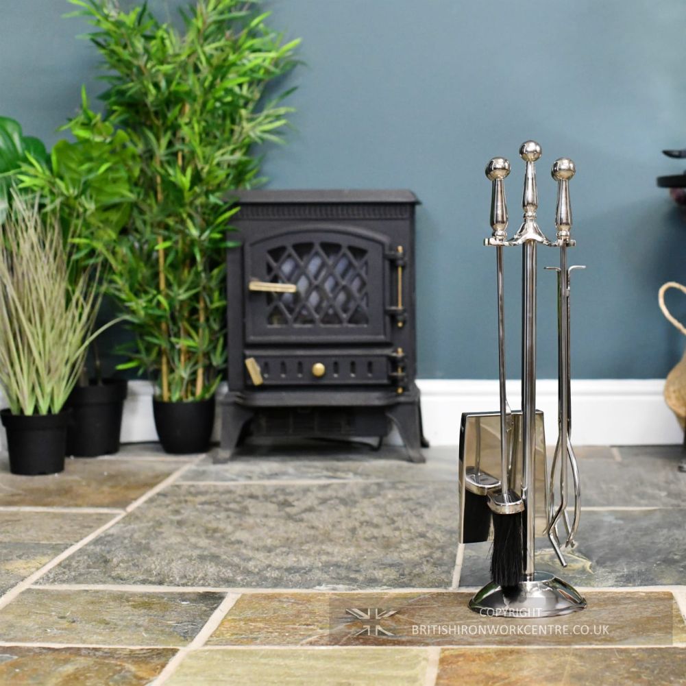 classic polished steel companion set on the right hand side in front of fireplace