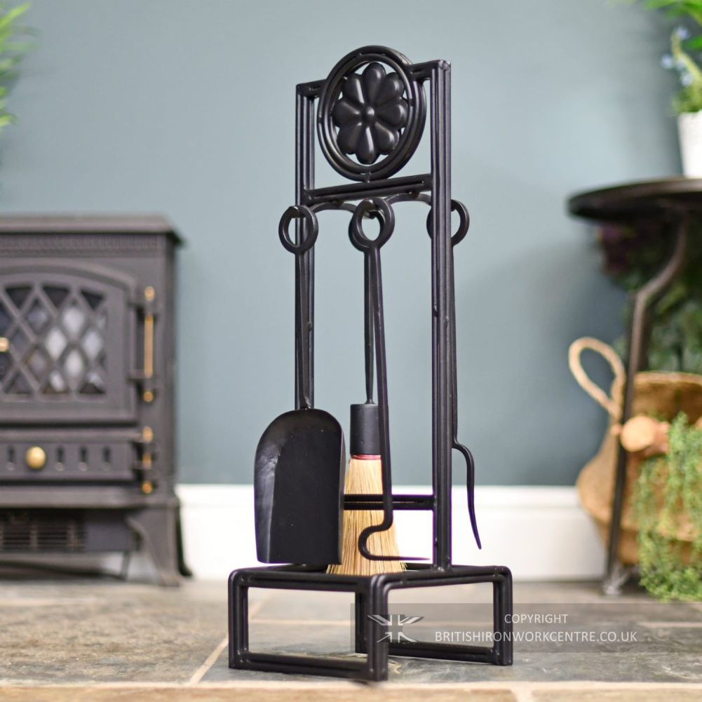 Elegant Black Iron Companion Set 62cm facing left in front of fireplace