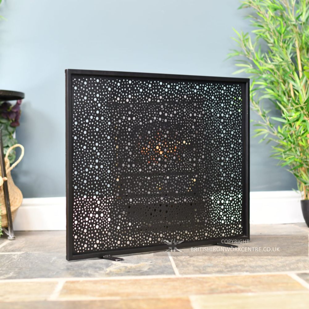 Circular Cut-Out Single Pane Black Fire Screen in front of fireplace at an angle