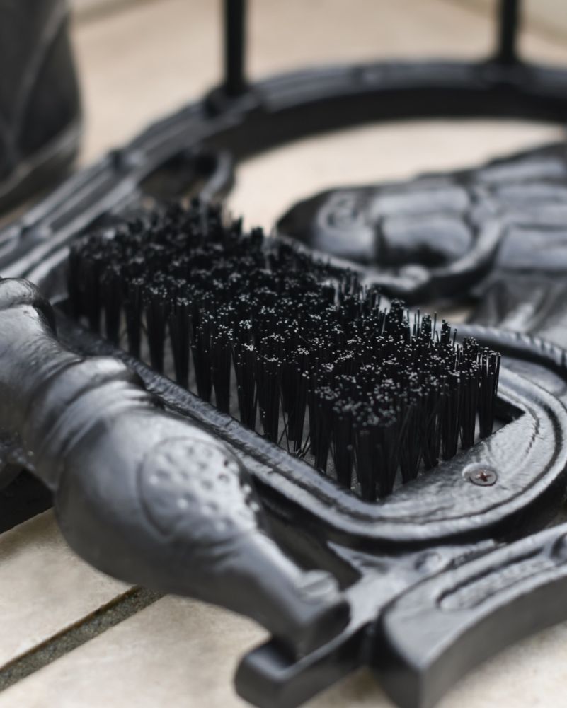 Close Up Of Horse Head Boot Stand & Scraper In Black Bristles