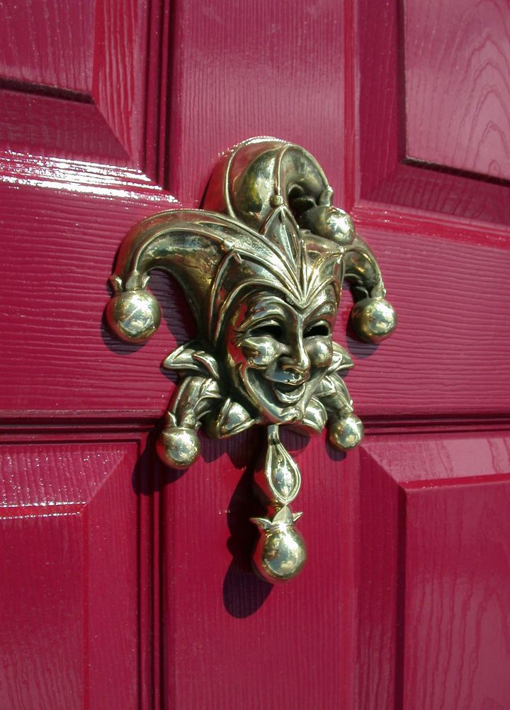 Jester Door Knocker - Polished Brass Finish on Red Door