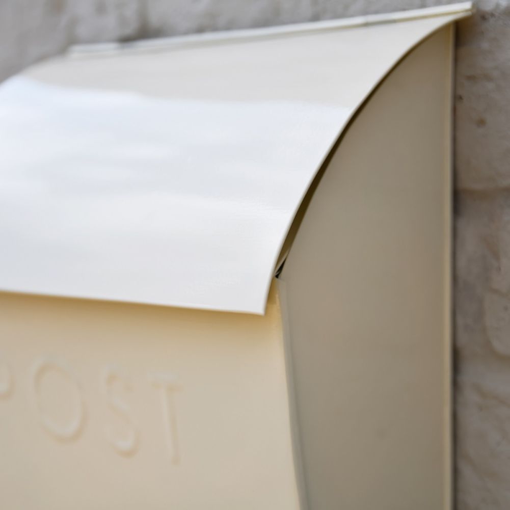 Close up of curved top on Cream Post Box 