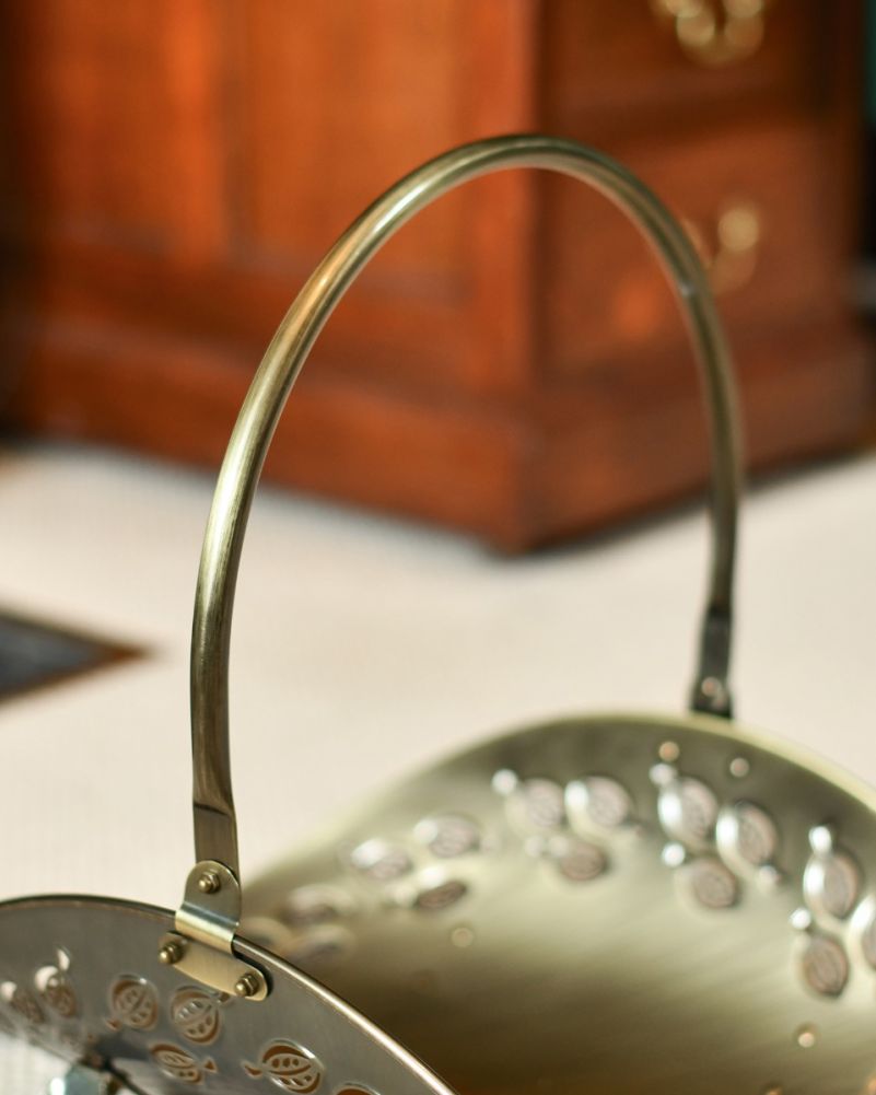 Close-Up of Looped Handle Antique Brass Log Store in Situ