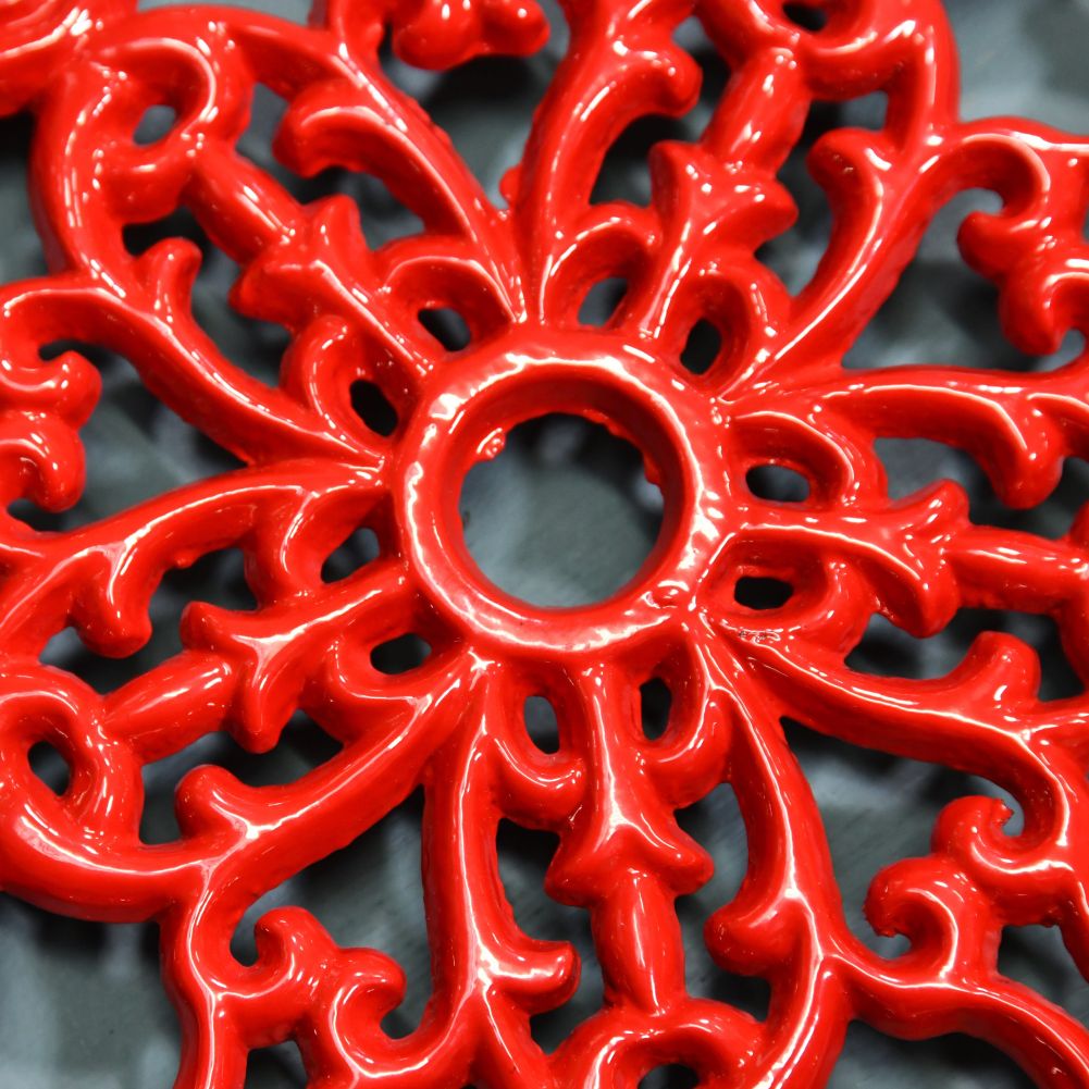 Red Cast Iron Flower Trivet Close-Up