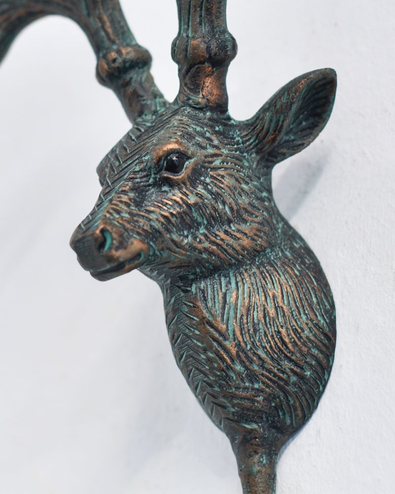 Close Up Of The Face Of Ornate Cast Aluminium Verdigris Elk Head Hook