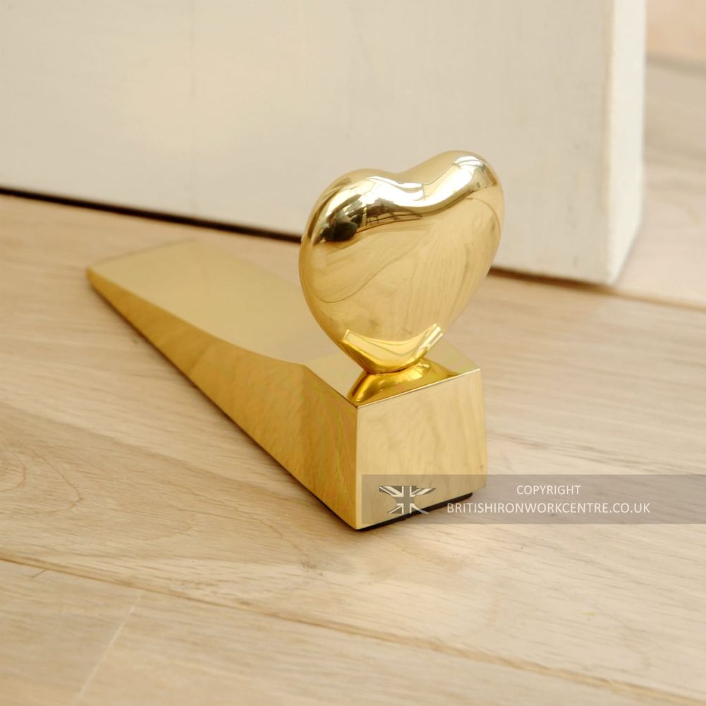 Polished Brass Delightful Chubby Heart Door Wedge In Living Room Setting