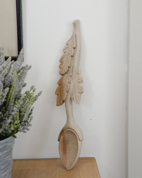 Intricate details of oak leaves on the love spoon