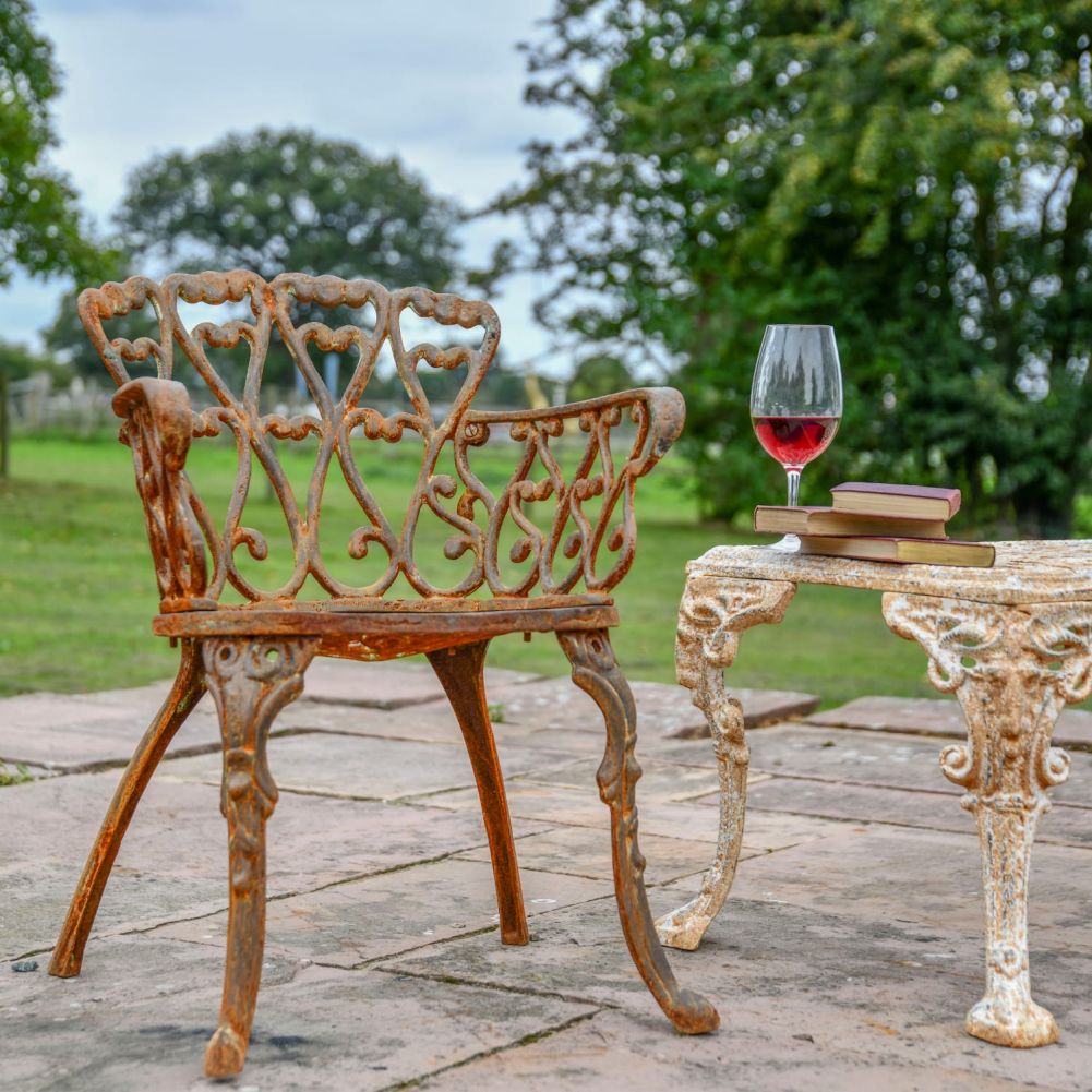 Cast Iron Heart Scrolled Garden Chair in a Rustic Finish In Situ