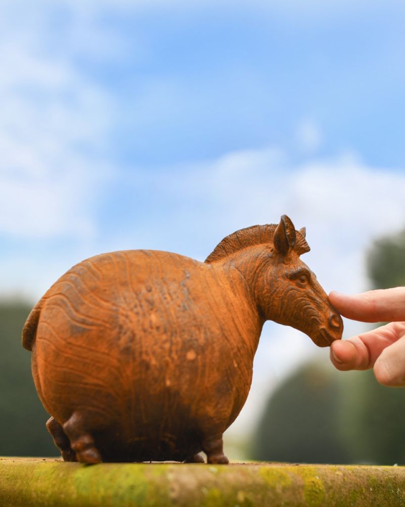 Scale Shot Of Rustic Cast Iron Round Zebra Sculpture