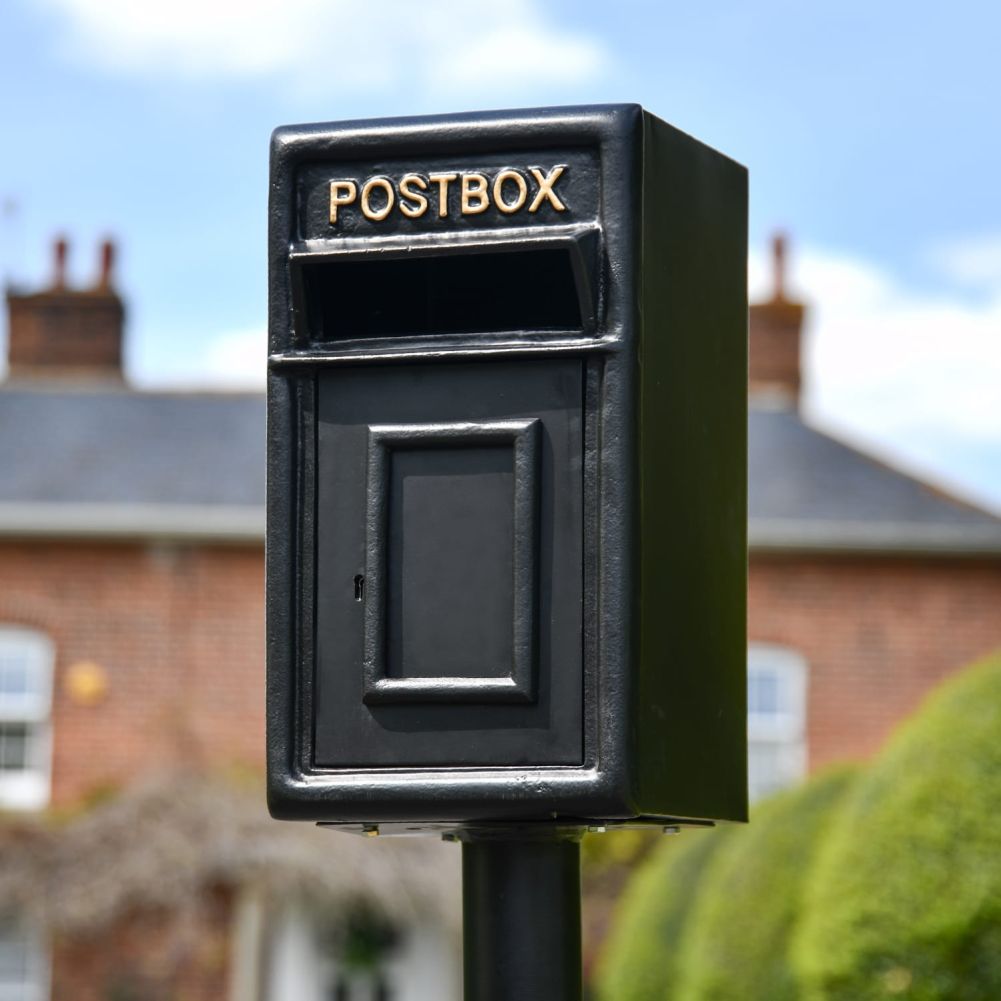 Black and Gold Traditional Iron Post Box With Stand In Situ
