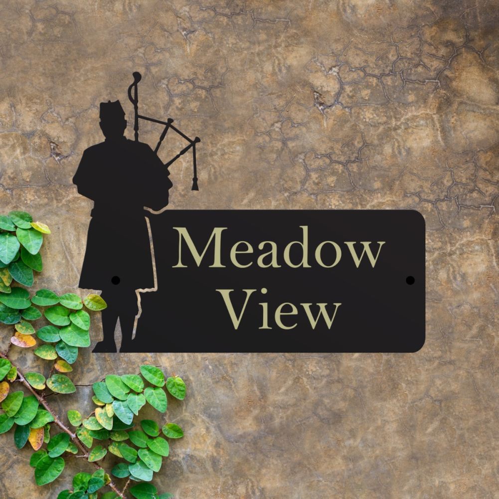 Steel Bagpiper House Sign On A Dark Wall