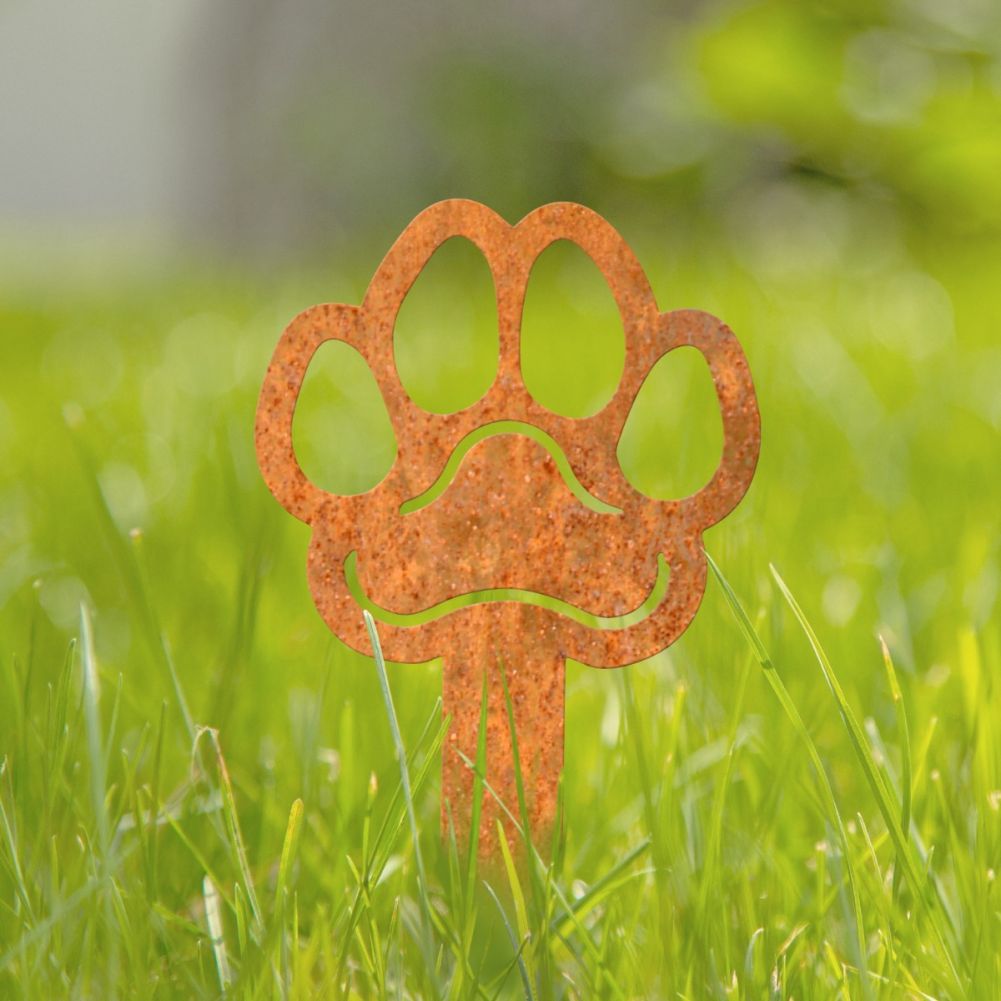 Steel Rustic Paw Print Grave Marker In A Grassy Setting