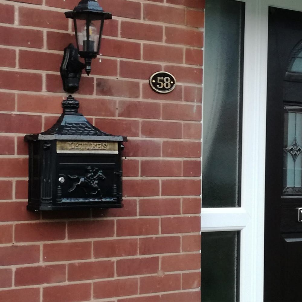 The Westminster Post Box In Midnight Black On Brick Wall