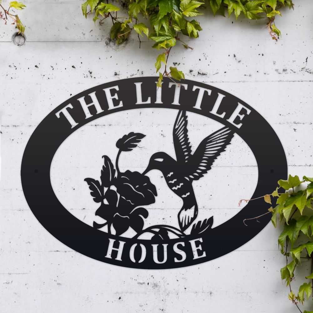 Hummingbird Oval House Name Sign On a White Brick Wall