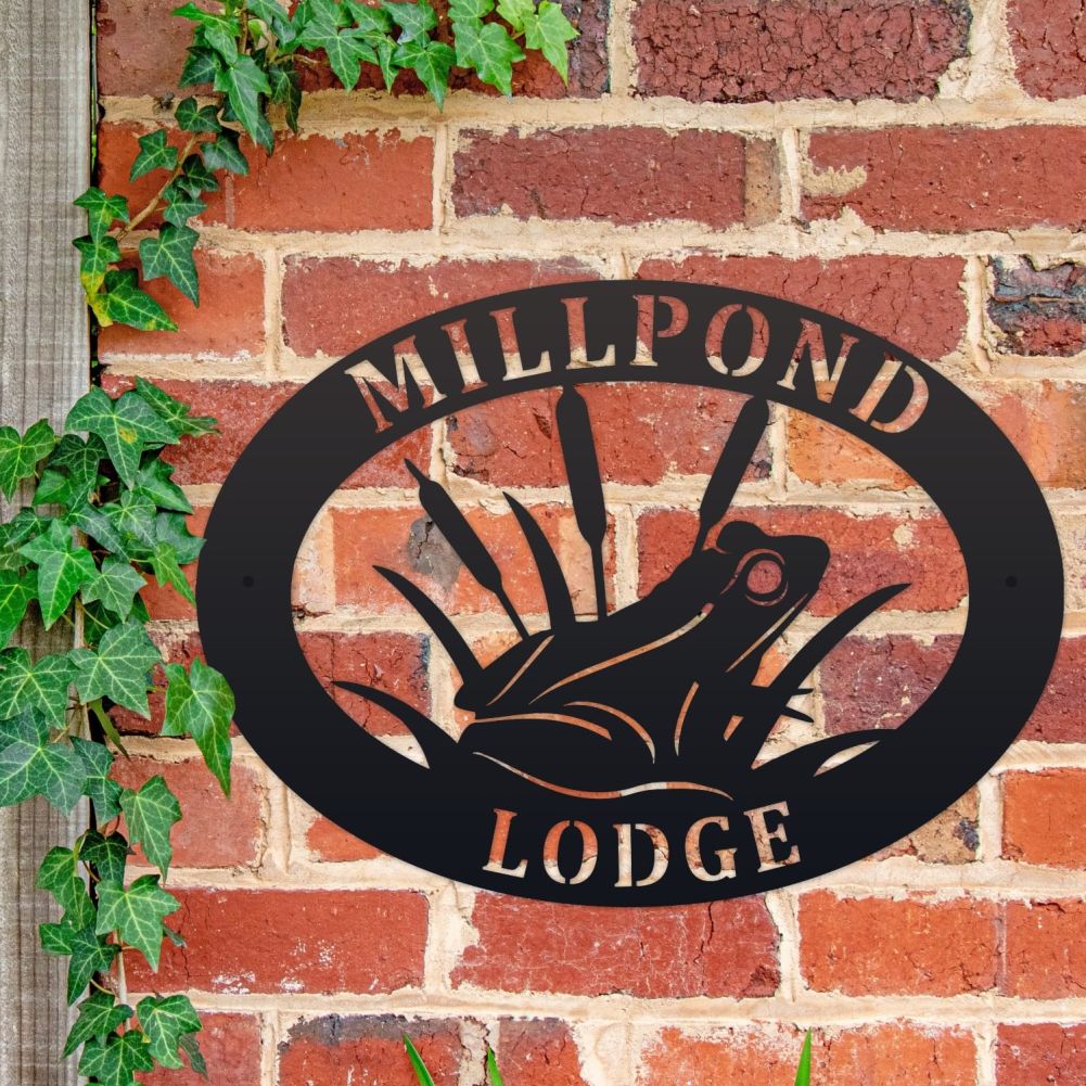 Frog Oval House Name Sign On a Brick Wall