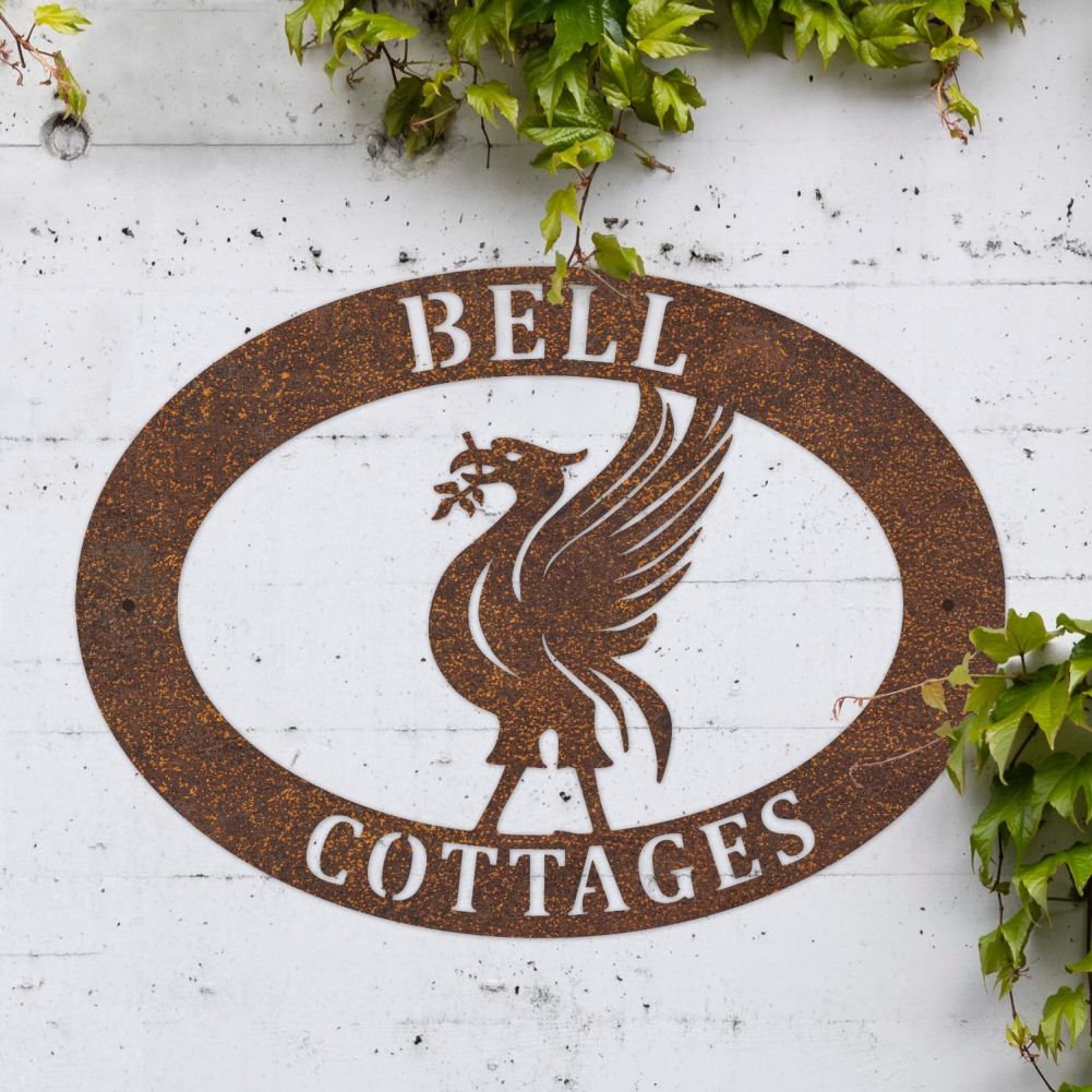 Rustic Liverbird Oval House Name Sign On a White Brick Wall