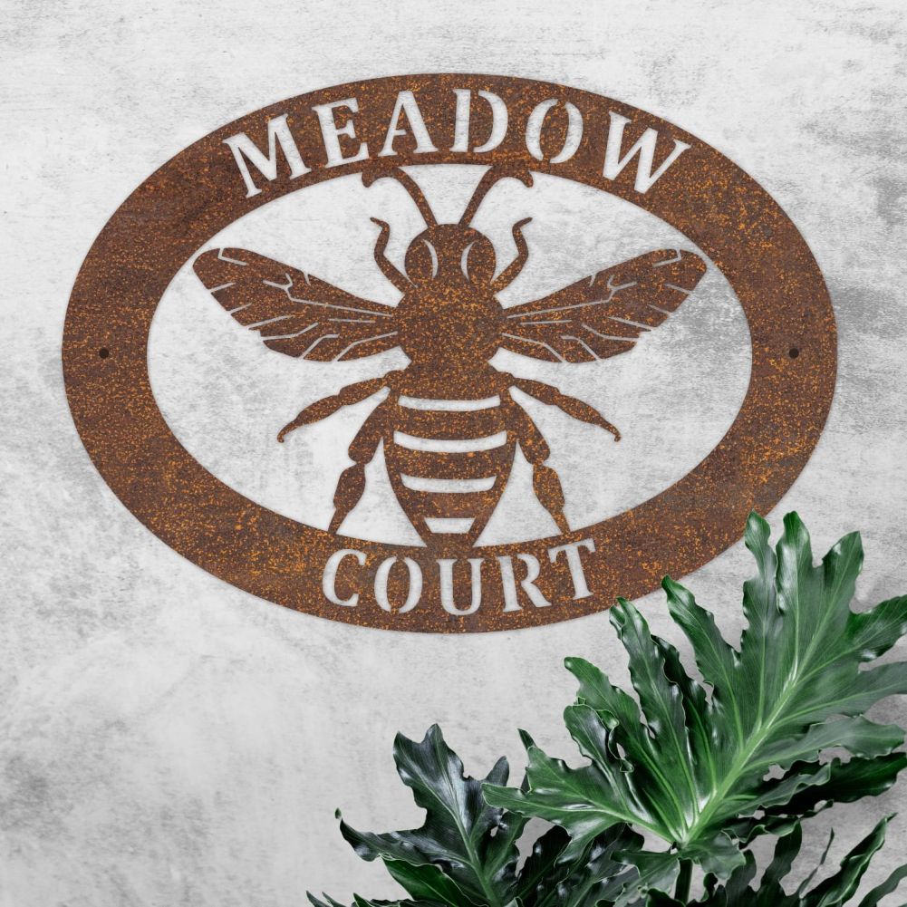 Rustic Bee Oval House Name Sign On a Rustic Wall