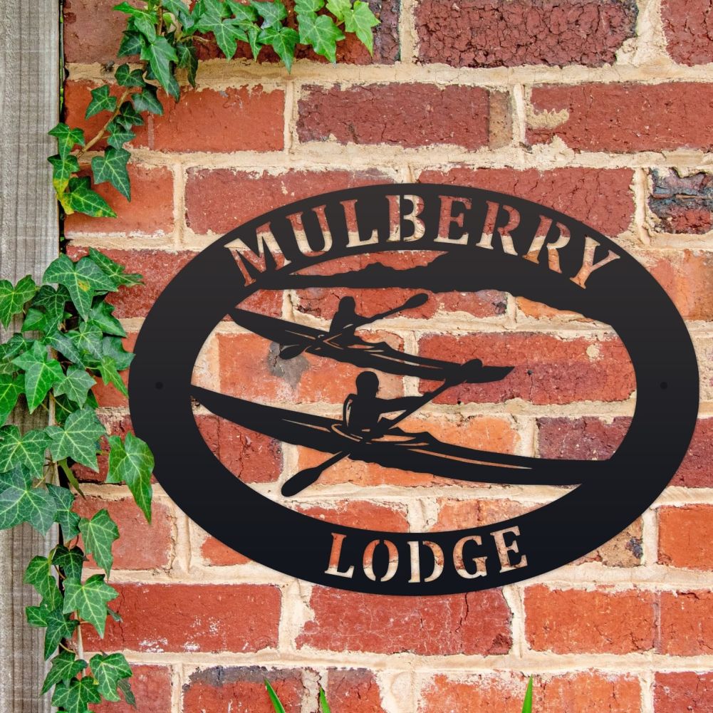 Kayak Oval House Name Sign On a Brick Wall