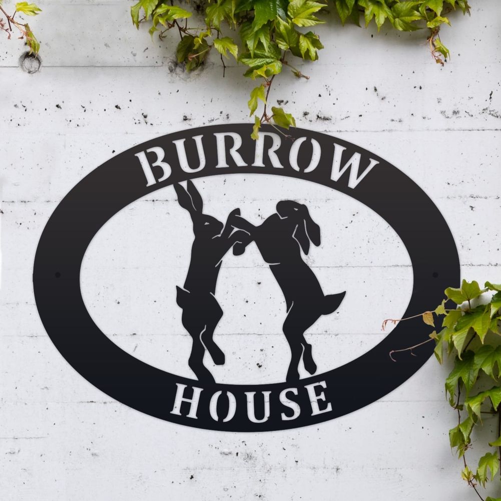 Boxing Hares Oval House Name Sign On a White Brick Wall
