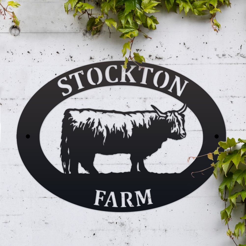 Highland Cow Oval House Name Sign On a White Brick Wall