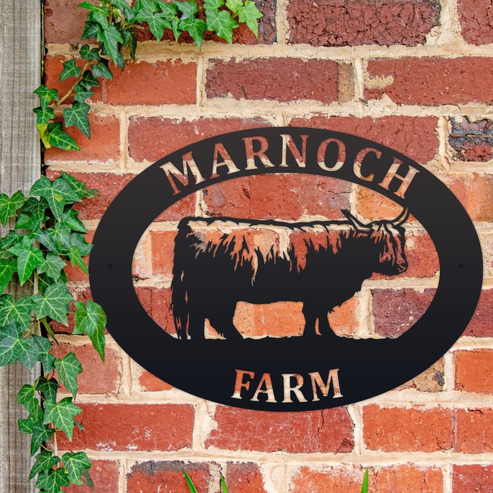 Highland Cow Oval House Name Sign On a Brick Wall