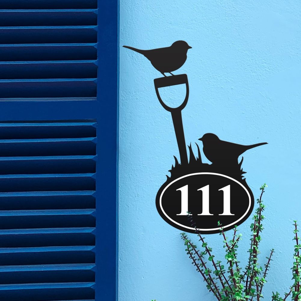 Robin Iron House Number Sign On a Blue Wall