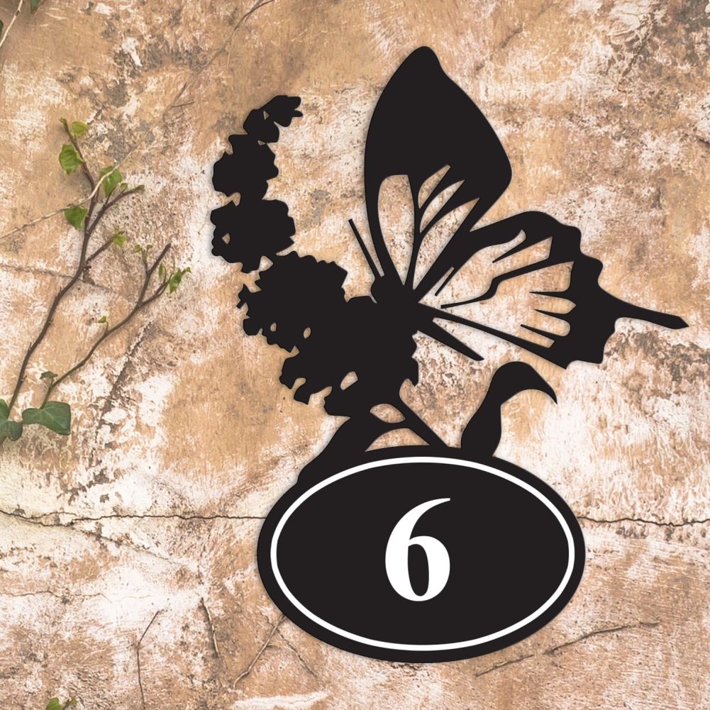 Butterfly Iron House Number Sign On a Rustic Wall
