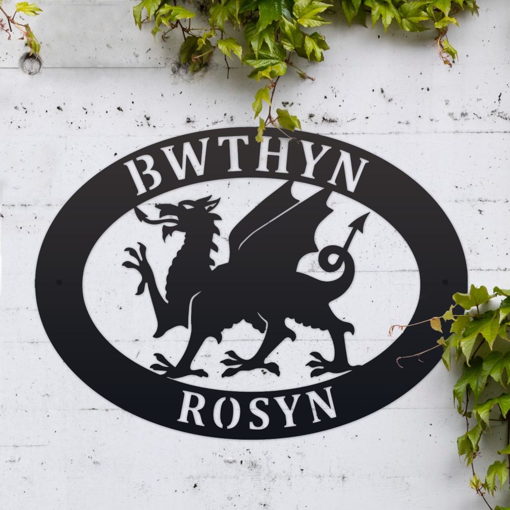 Welsh Dragon Oval House Name Sign On a White Brick Wall
