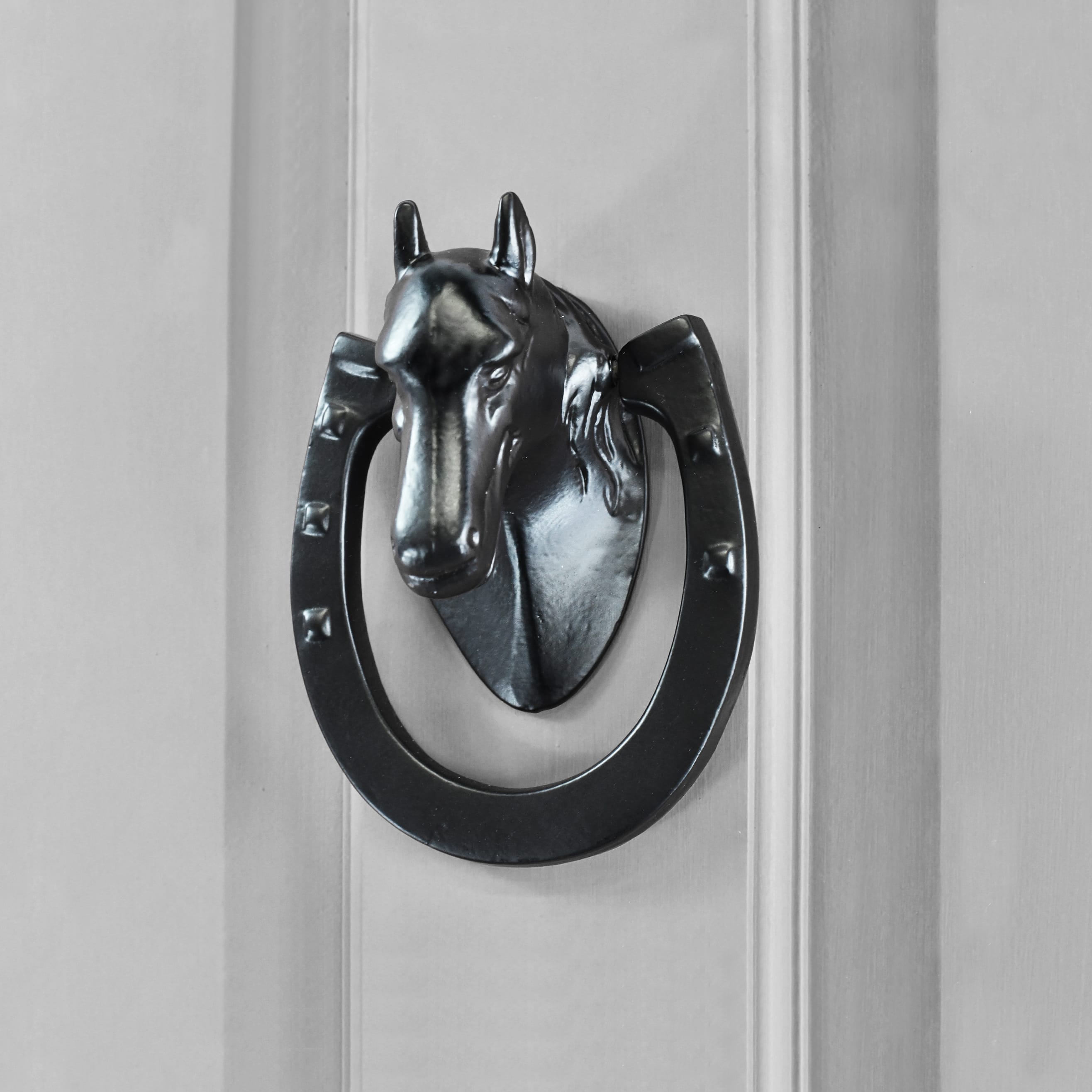 Black Iron Horse Shoe Door Knocker on Door