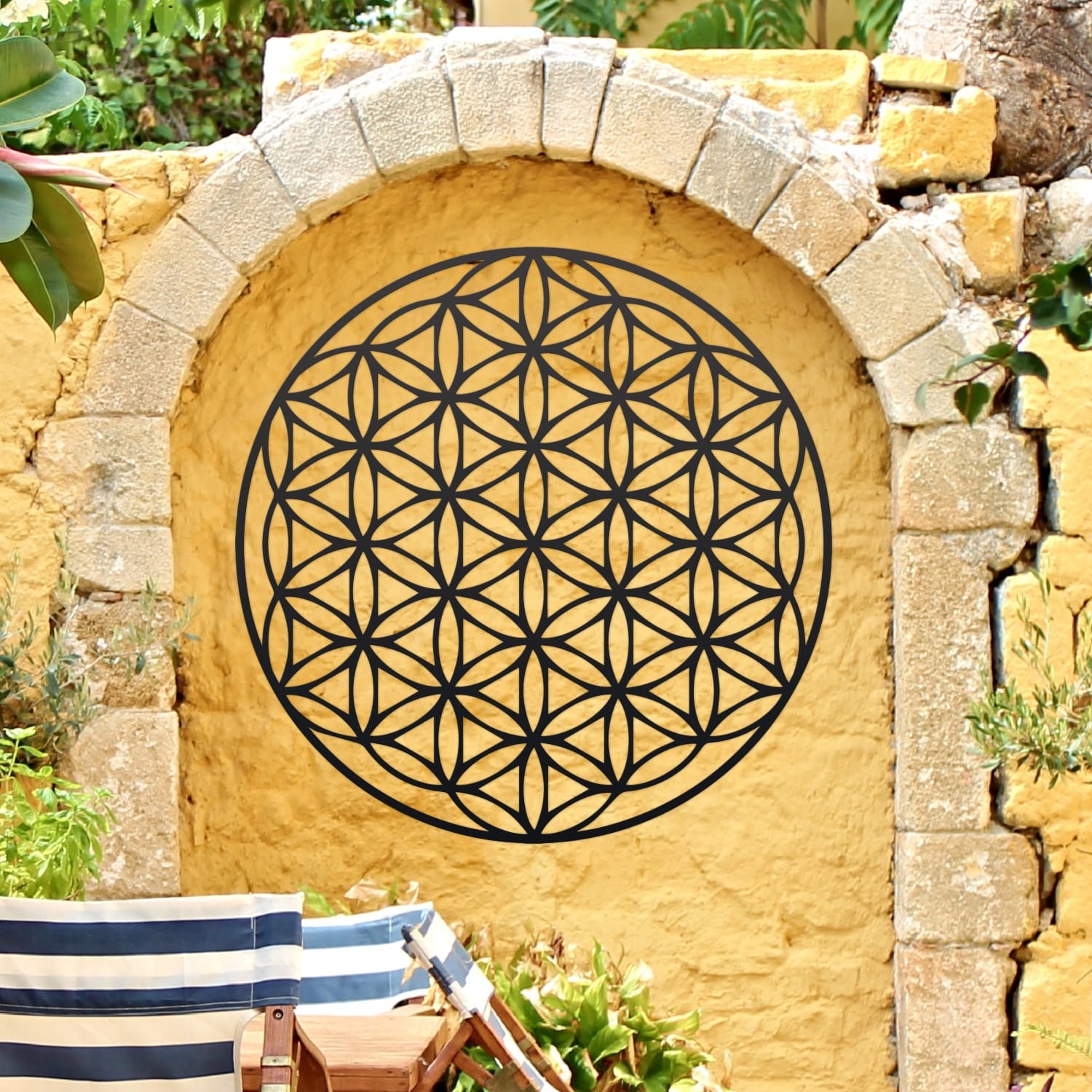 Sacred Geometry "Flower of Life" Black Wall Art On a Yellow Outside Wall