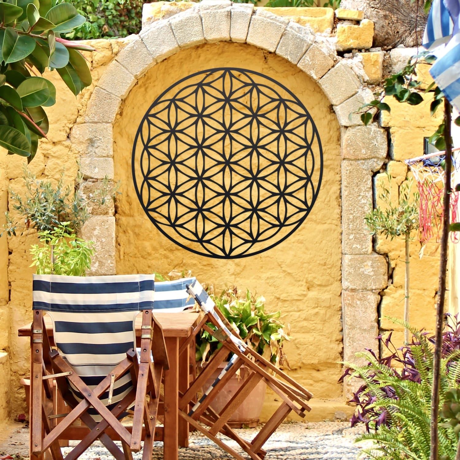 Sacred Geometry "Flower of Life" Black Wall Art On a Yellow Garden Wall