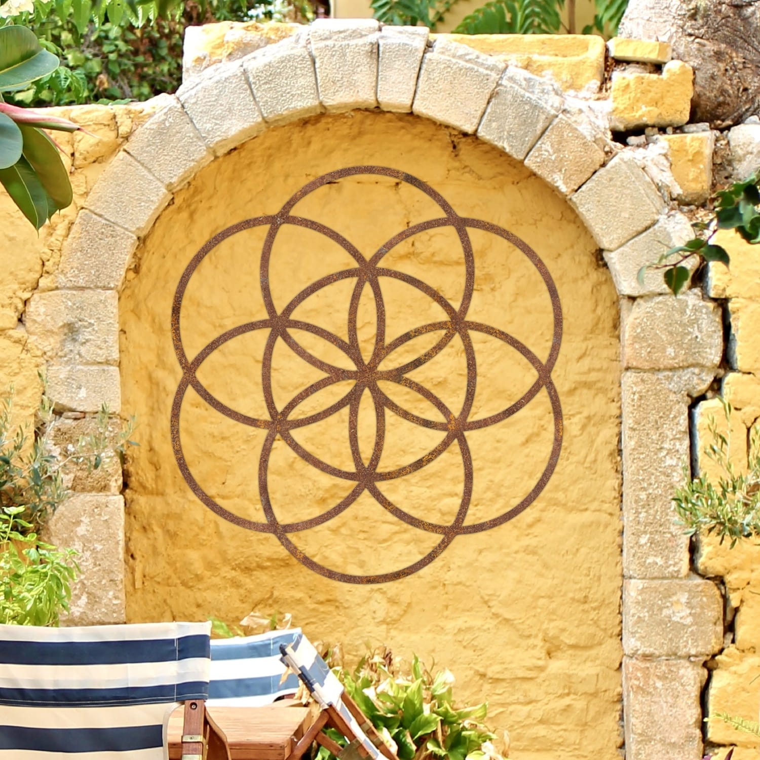 Rustic "Seed of Life" Steel Wall Art On a Yellow Wall