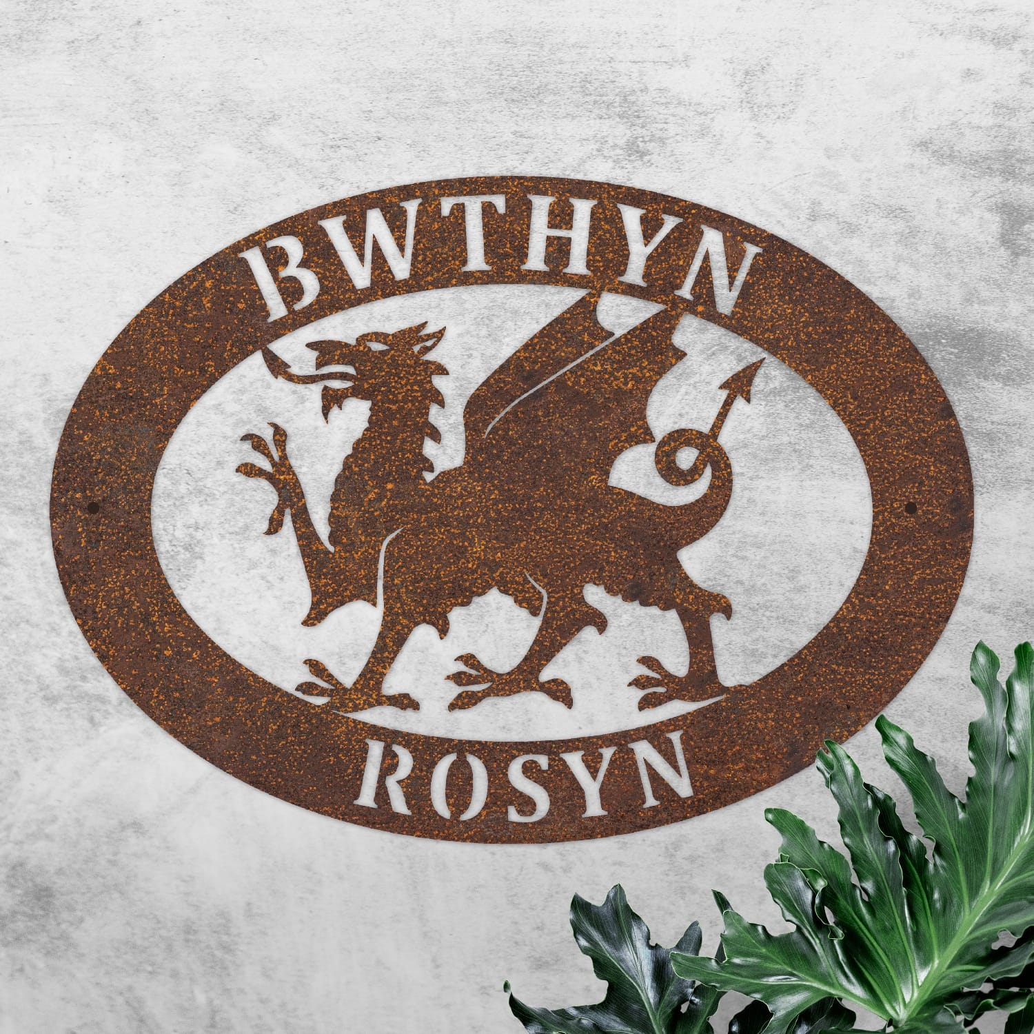Rustic Welsh Dragon Oval House Name Sign On a Rustic Wall