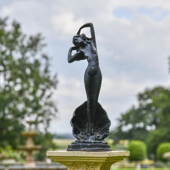 Lady Standing on Clam Sculpture