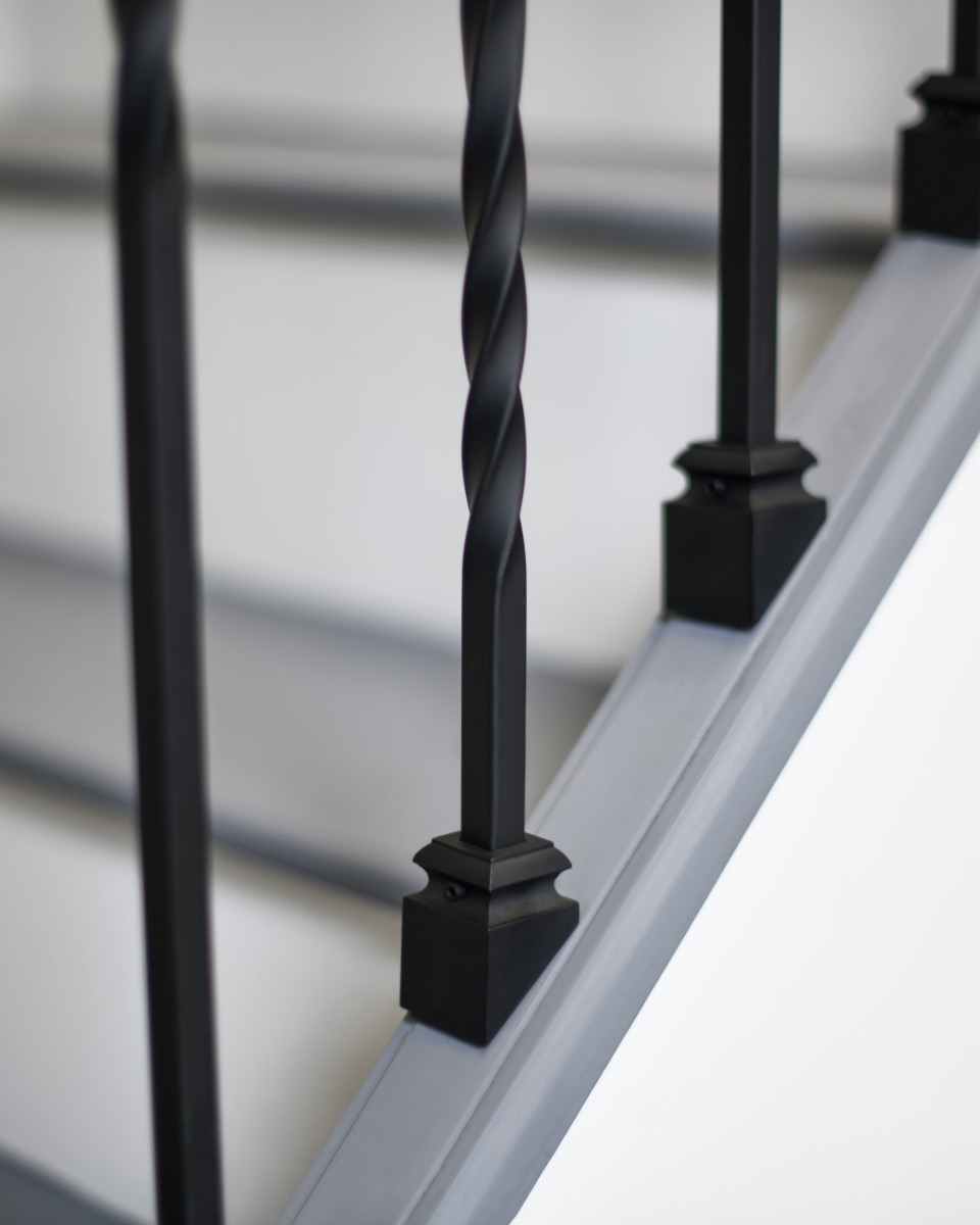 Close Up Of Set of 2 Steel "Redbridge & Trinity" Stair Spindles in Matte Black (Pattern 4) Brackets